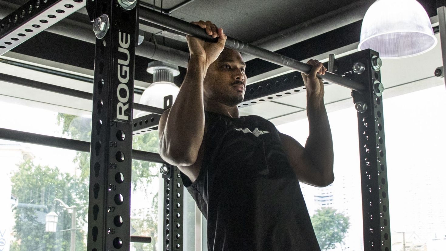 Amir Khan doing a pull-up at the gym.